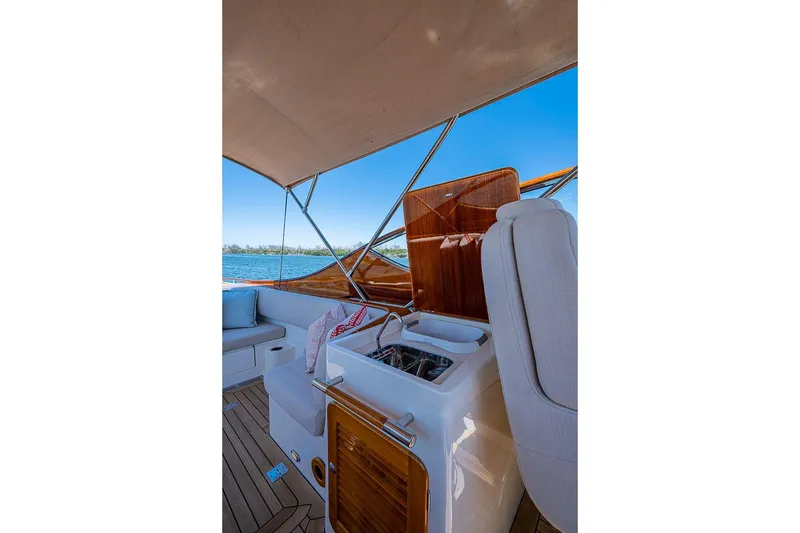 Slide: The Image of 2017 Hinckley Talaria 34R yacht interior with seating and wooden accents. - 10