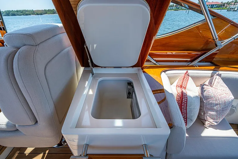 Slide: The Image of Hinckley Talaria 34R 2017 yacht interior with open storage compartment and cushions. - 11