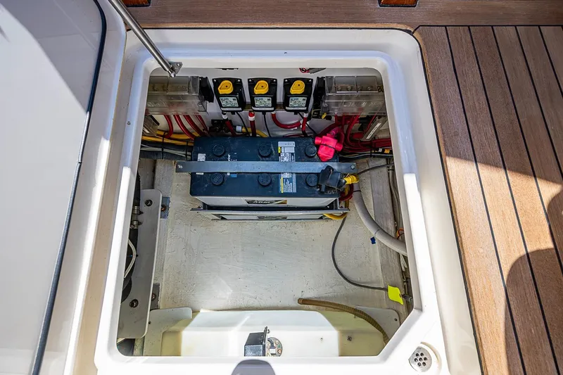 Slide: The Image of 2017 Hinckley Talaria 34R boat battery compartment with wiring and components. - 16
