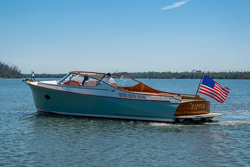 Slide: The Image of 2017 Hinckley Talaria 34R cruising on a sunny day with American flag displayed. - 18