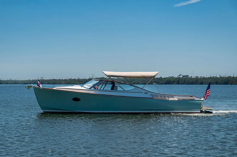 Slide: The Image of 2017 Hinckley Talaria 34R cruising on a calm lake under a clear blue sky. - 19