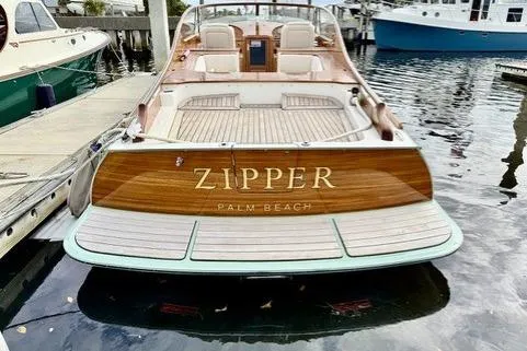 Slide: The Image of 2017 Hinckley Talaria 34R boat named "Zipper" docked in Palm Beach marina. - 2