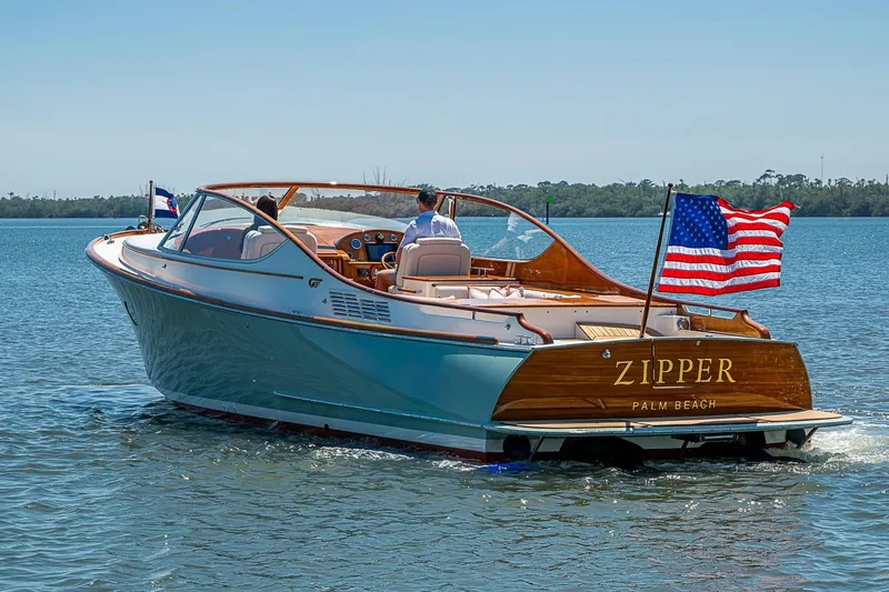 Slide: The Image of 2017 Hinckley Talaria 34R boat named "Zipper" cruising on calm waters. - 22