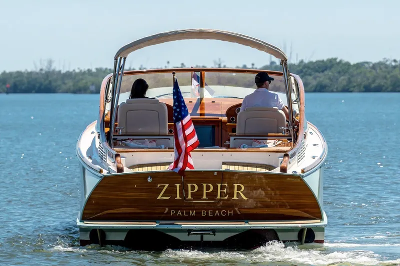 Slide: The Image of Hinckley Talaria 34R 2017 boat named "Zipper" cruising on calm waters. - 24
