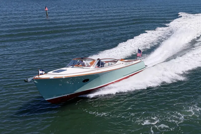 Slide: The Image of 2017 Hinckley Talaria 34R cruising on open water, showcasing sleek design and performance. - 26