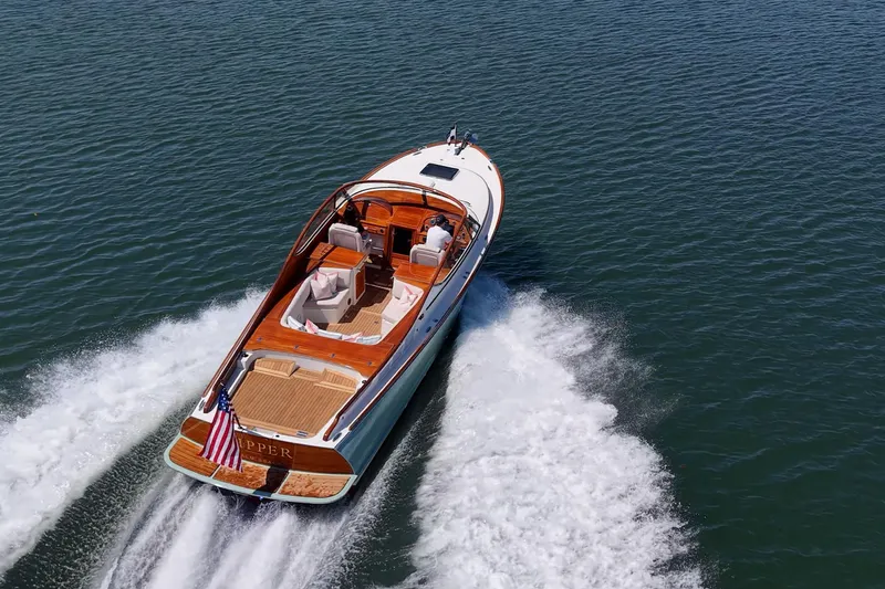 Slide: The Image of 2017 Hinckley Talaria 34R cruising on open water, showcasing elegant design and performance. - 28