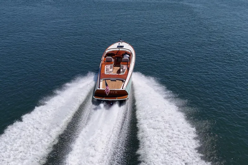 Slide: The Image of 2017 Hinckley Talaria 34R cruising on open water, leaving a wake behind. - 29