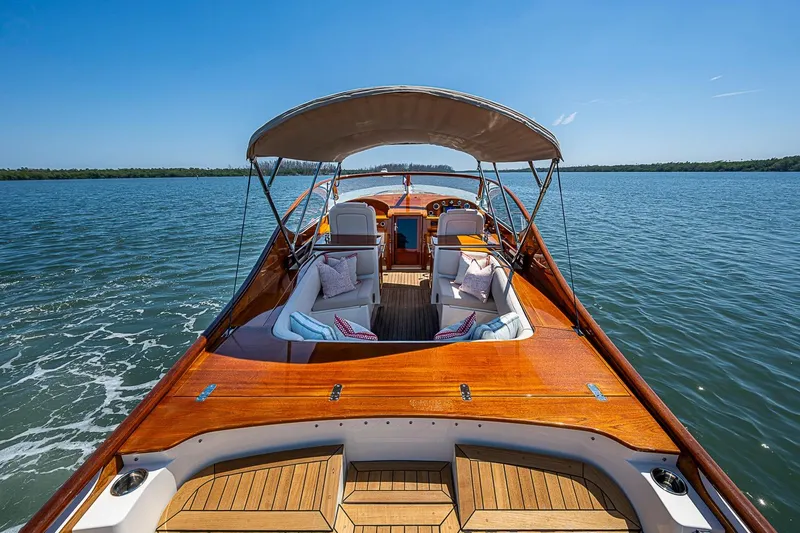 Slide: The Image of 2017 Hinckley Talaria 34R cruising on open water under clear blue skies. - 3