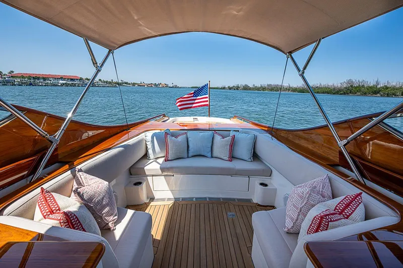 Slide: The Image of Hinckley Talaria 34R 2017 yacht interior with plush seating and American flag on water. - 4