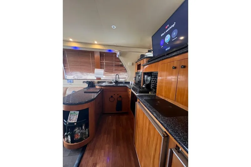 Slide: The Image of Luxurious kitchen interior of 2000 Carver 530 Voyager Pilothouse yacht with modern amenities. - 15