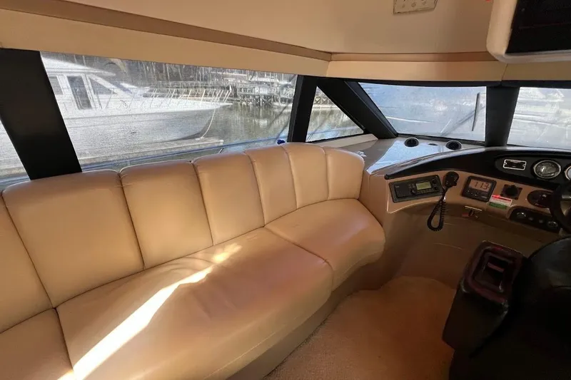 Slide: The Image of Interior of 2000 Carver 530 Voyager Pilothouse with beige seating and control panel. - 16