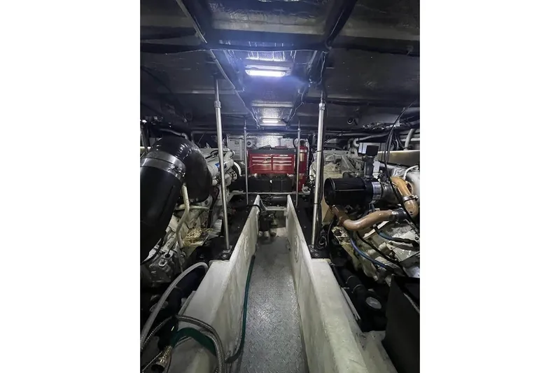 Slide: The Image of Engine room of a 2000 Carver 530 Voyager Pilothouse, showcasing mechanical components. - 24