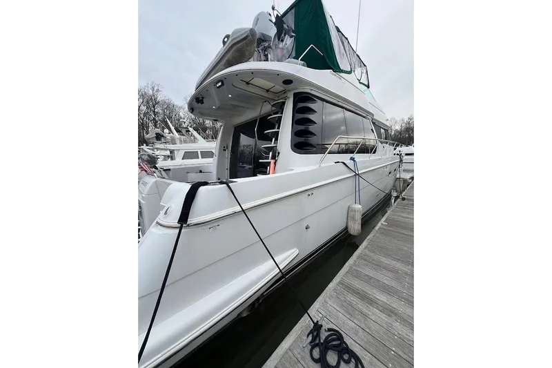 Slide: The Image of 2000 Carver 530 Voyager Pilothouse yacht docked at marina, side view. - 4