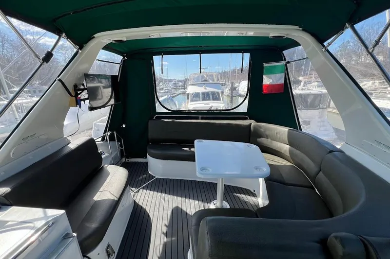 Slide: The Image of Interior of 2000 Carver 530 Voyager Pilothouse with seating and table, docked at marina. - 9