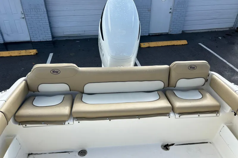 Slide: The Image of 2019 Key West 239 FS boat with beige and white cushioned seating. - 15