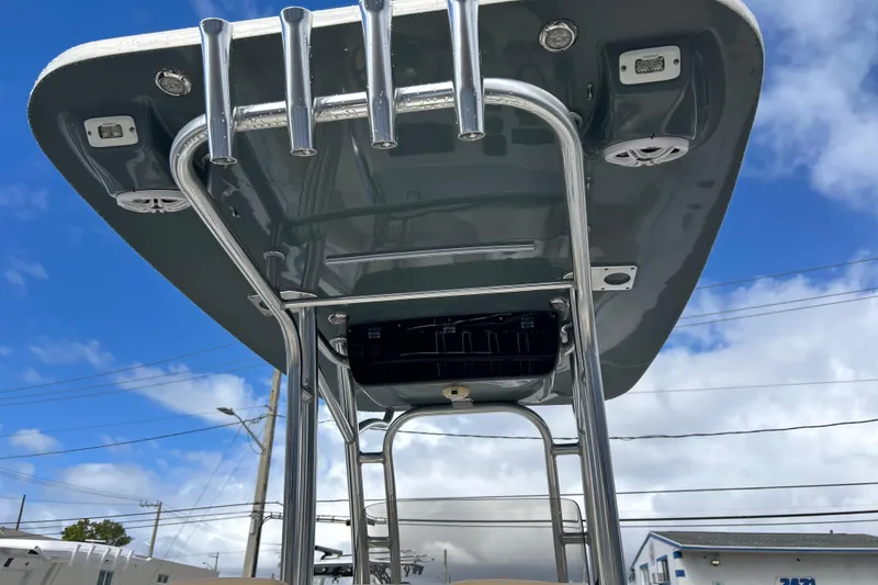 Slide: The Image of 2019 Key West 239 FS boat T-top with rod holders against blue sky. - 16