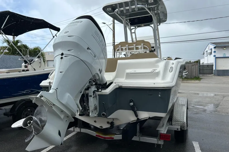 Slide: The Image of 2019 Key West 239 FS boat on trailer, featuring a powerful outboard motor. - 18