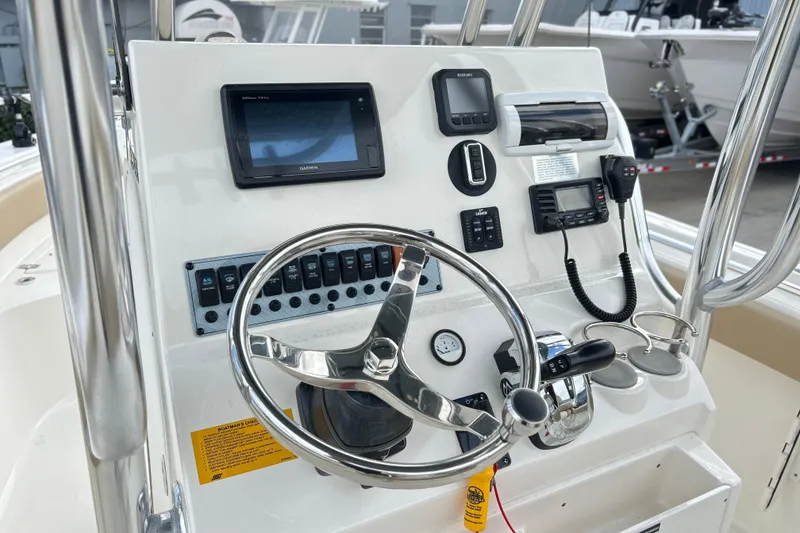 Slide: The Image of 2019 Key West 239 FS boat dashboard with steering wheel and navigation controls. - 3