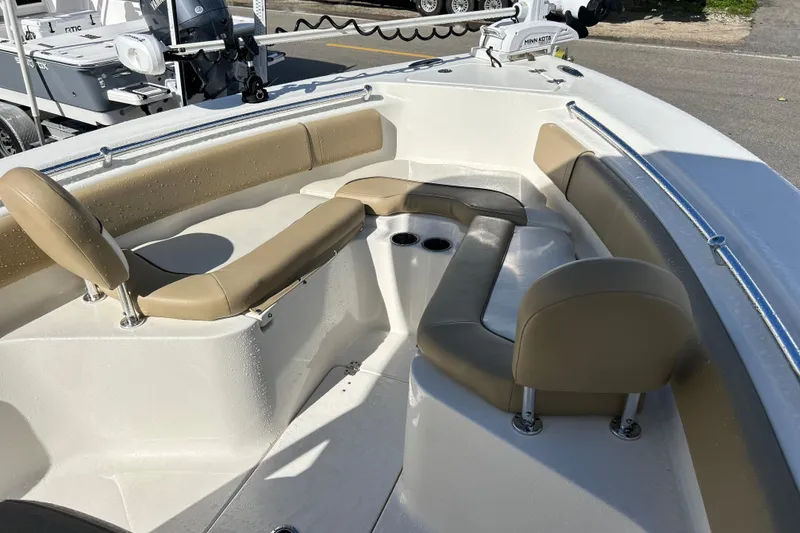 Slide: The Image of 2019 Key West 239 FS boat interior with tan seating and cup holders. - 9