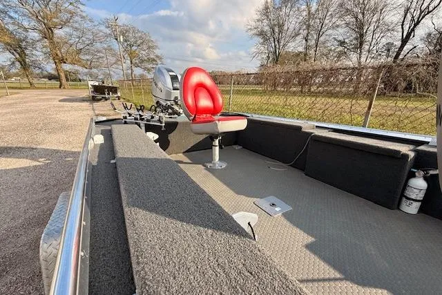 Slide: The Image of 2022 Rhino V Pro Stick boat with red seat, outdoor setting, and motor. - 4