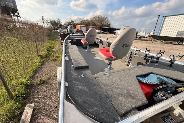 Slide: The Image of 2022 Rhino V Pro Stick boat with red seats and fishing rod holders. - 7