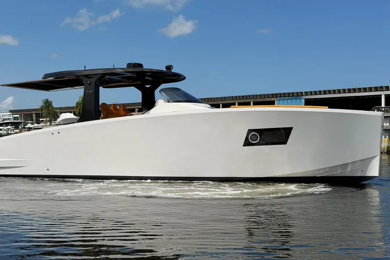 Slide: The Image of 2024 Tesoro T40 yacht on water, sleek design, sunny day, marina backdrop. - 10