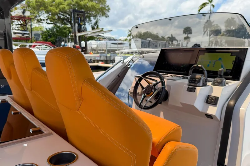 Slide: The Image of 2024 Tesoro T40 boat interior with orange seats and modern navigation dashboard. - 15