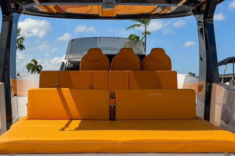 Slide: The Image of 2024 Tesoro T40 yacht with luxurious orange seating, palm trees in the background. - 17