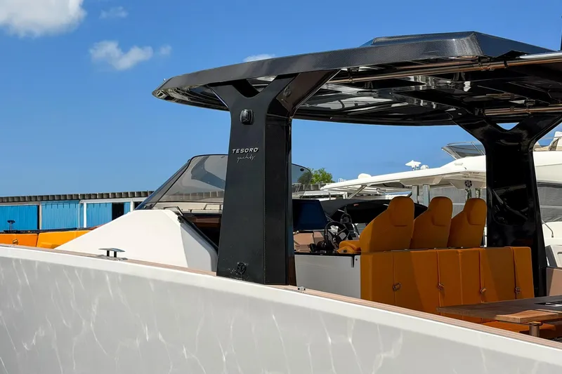 Slide: The Image of 2024 Tesoro T40 yacht with sleek design and orange seating under a clear blue sky. - 21