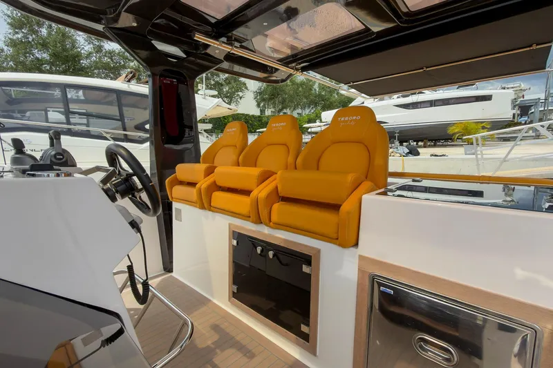 Slide: The Image of 2024 Tesoro T40 yacht interior with luxurious orange seating and modern steering console. - 25