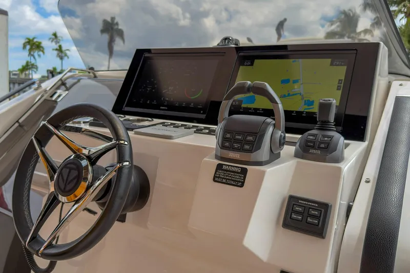 Slide: The Image of 2024 Tesoro T40 yacht dashboard with steering wheel and navigation screens. - 27