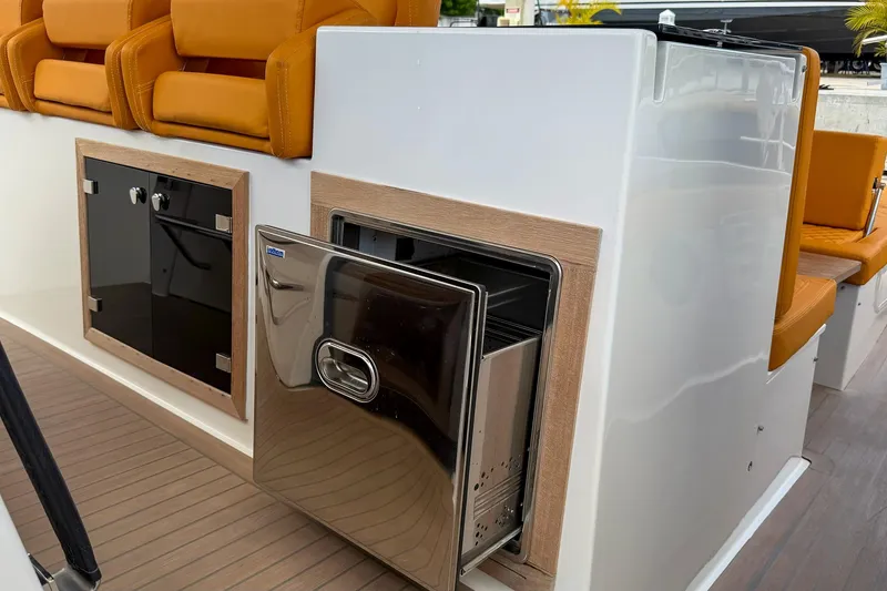 Slide: The Image of 2024 Tesoro T40 yacht interior with stainless steel drawer and orange seating. - 32