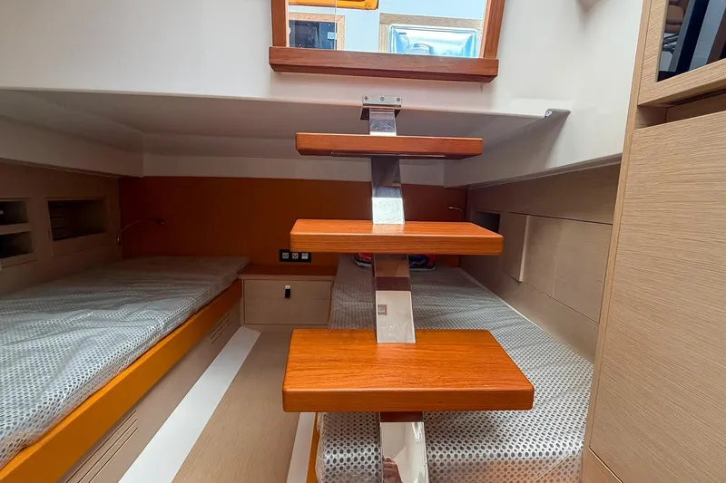 Slide: The Image of Interior of 2024 Tesoro T40 yacht with wooden steps and cozy sleeping area. - 34