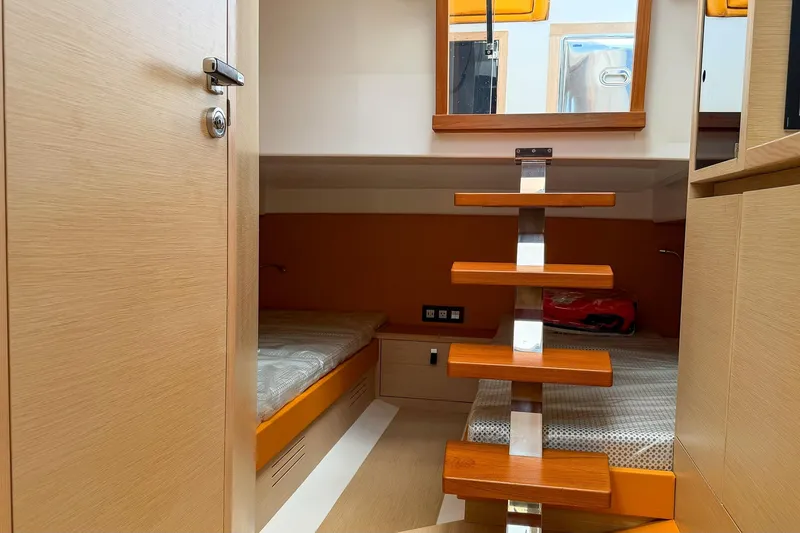 Slide: The Image of Interior of 2024 Tesoro T40 yacht cabin with wooden steps and cozy beds. - 36