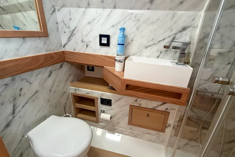 Slide: The Image of Luxurious Tesoro T40 2024 yacht bathroom with marble walls and modern fixtures. - 40
