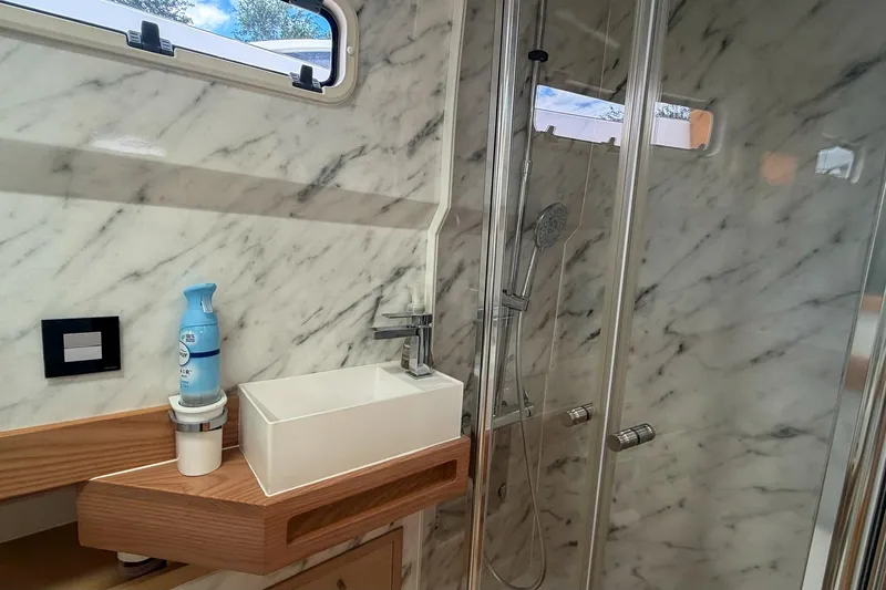 Slide: The Image of Luxurious marble bathroom in 2024 Tesoro T40 yacht with modern sink and shower. - 41