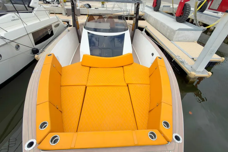 Slide: The Image of 2024 Tesoro T40 boat with vibrant orange seating docked at marina. - 42
