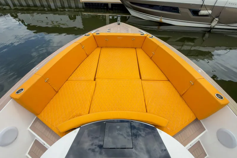 Slide: The Image of 2024 Tesoro T40 boat with vibrant orange seating, docked by the water. - 44