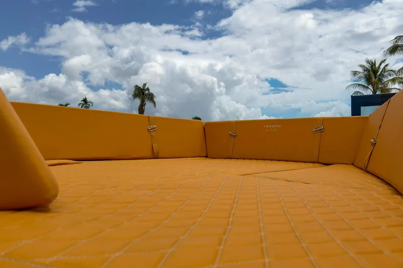Slide: The Image of Luxurious Tesoro T40 yacht deck with orange seating, 2024 model, under a partly cloudy sky. - 46