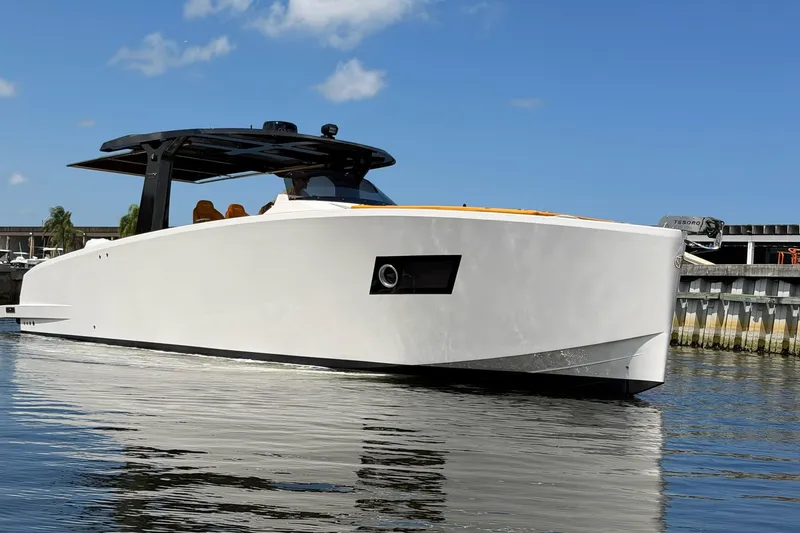 Slide: The Image of 2024 Tesoro T40 luxury yacht on calm water under clear blue sky. - 8