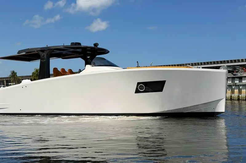 Slide: The Image of 2024 Tesoro T40 luxury yacht cruising on calm water under a clear blue sky. - 9