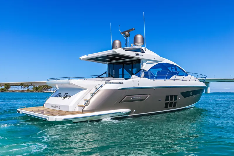 Slide: The Image of 2020 Azimut S6 yacht cruising on clear blue waters under a sunny sky. - 31