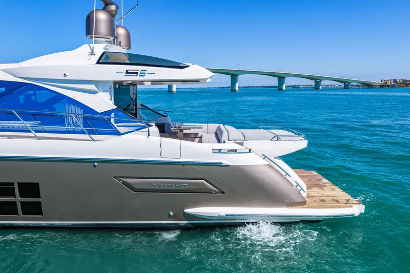 Slide: The Image of 2020 Azimut S6 yacht cruising near a bridge on clear blue waters. - 24