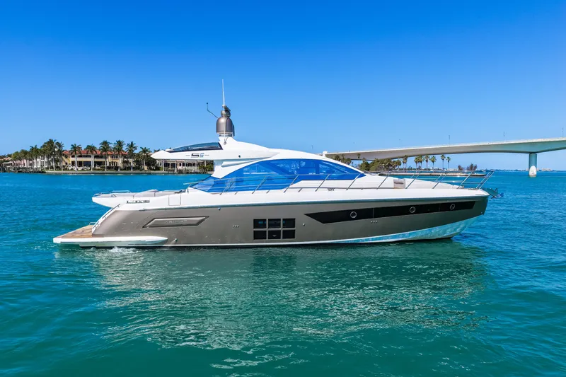 Slide: The Image of 2020 Azimut S6 yacht cruising on clear blue waters near a bridge. - 32