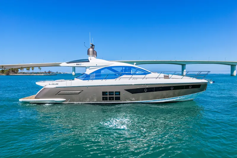 Slide: The Image of 2020 Azimut S6 yacht cruising on clear blue waters near a bridge. - 37