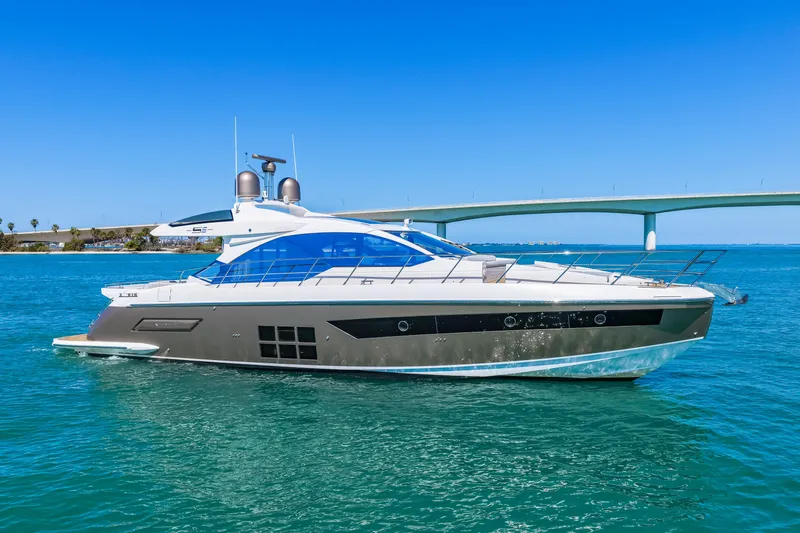 Slide: The Image of 2020 Azimut S6 yacht cruising on clear blue water near a bridge. - 38