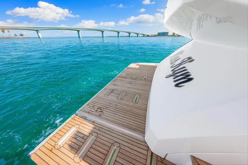 Slide: The Image of Luxury Azimut S6 yacht deck overlooking turquoise waters and a scenic bridge, 2020 model. - 85