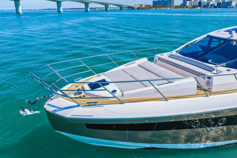 Slide: The Image of 2020 Azimut S6 yacht cruising on clear blue waters near a bridge. - 23