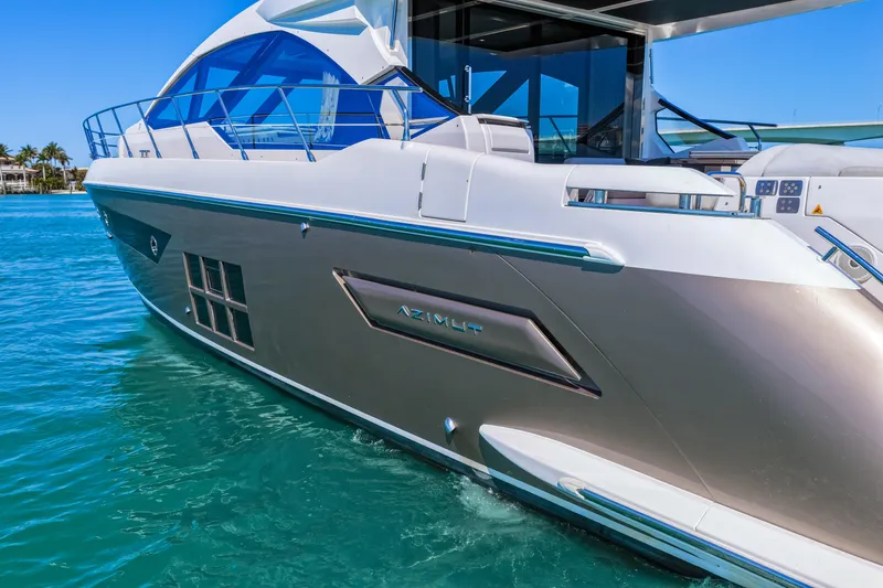 Slide: The Image of 2020 Azimut S6 yacht cruising on clear blue water under a sunny sky. - 21