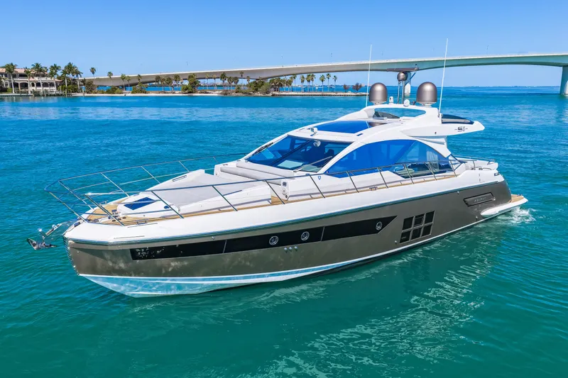 Slide: The Image of 2020 Azimut S6 yacht cruising on clear blue water near a bridge. - 4